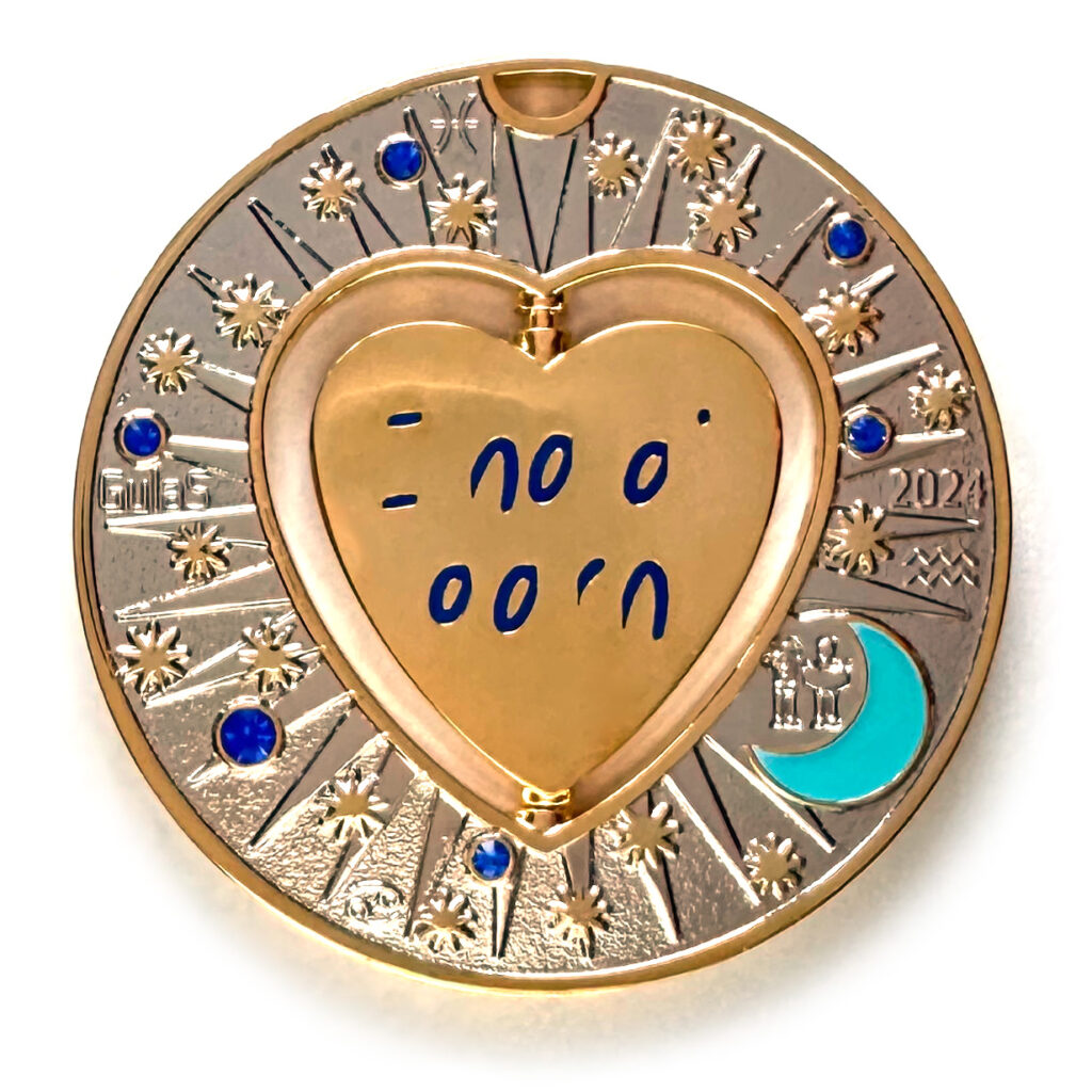 gulas geocoin, gold and nickel, a geocoin with a heart in the center